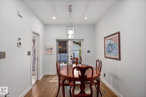 Dining area featuring wood-finish flooring and light-toned walls - 14221 101 Avenue Nw, Edmonton, AB - Indoor Photo Showing Dining Room