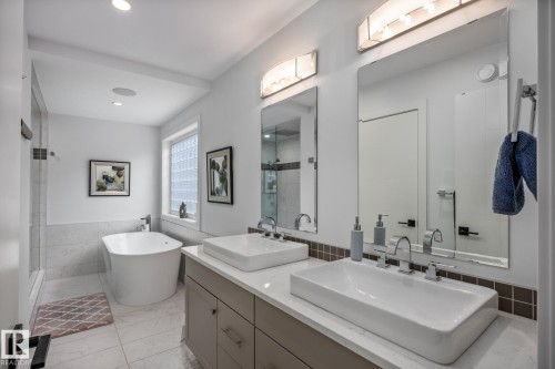 Contemporary bathroom featuring a dual vanity with vessel sinks, white countertops, and light gray cabinetry - 14221 101 Avenue Nw, Edmonton, AB - Indoor Photo Showing Bathroom