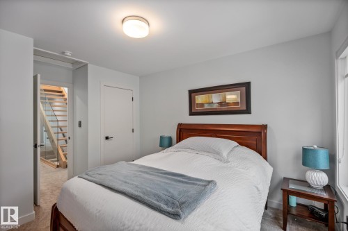 Bedroom featuring light-toned walls, a flush-mount ceiling light, and carpeted flooring - 14221 101 Avenue Nw, Edmonton, AB - Indoor Photo Showing Bedroom