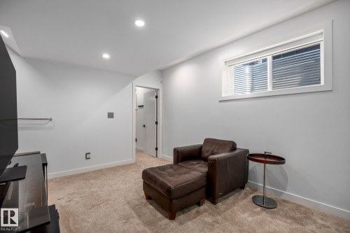 Carpeted room featuring recessed lighting, a horizontal window with blinds, and a white interior door - 14221 101 Avenue Nw, Edmonton, AB - Indoor