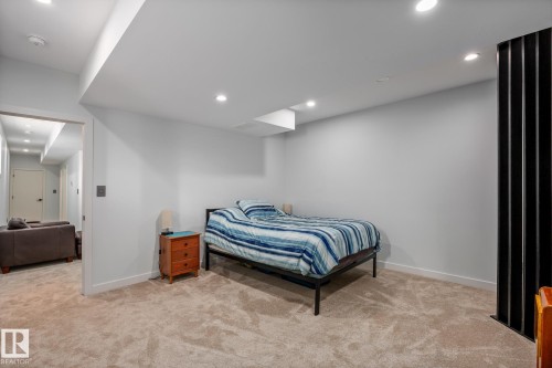 Spacious room featuring neutral carpeting, recessed lighting, and light-toned walls - 14221 101 Avenue Nw, Edmonton, AB - Indoor Photo Showing Bedroom