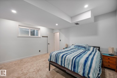 Bedroom featuring recessed lighting, a window with horizontal blinds, light-toned carpeting, and white walls - 14221 101 Avenue Nw, Edmonton, AB - Indoor Photo Showing Bedroom