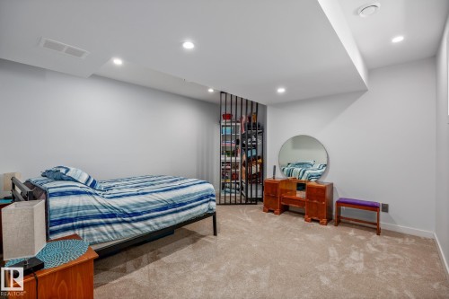 Carpeted room featuring recessed lighting, light-toned walls, and a partial decorative room divider - 14221 101 Avenue Nw, Edmonton, AB - Indoor Photo Showing Bedroom