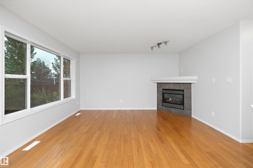 161 Rue Magnan, Beaumont, AB - Indoor Photo Showing Living Room With Fireplace