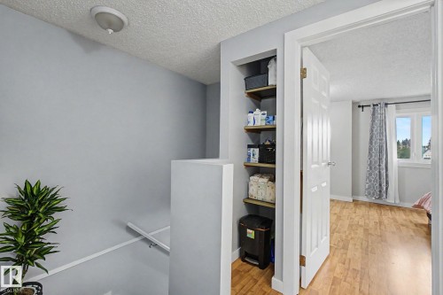 Recessed shelving with wood-finish shelves provides storage - 18407 95A Avenue Nw, Edmonton, AB - Indoor Photo Showing Other Room
