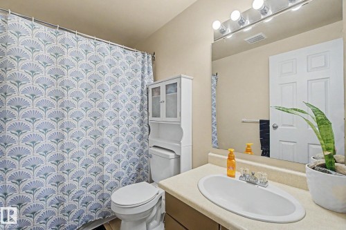 Bathroom featuring a built-in vanity with an oval basin, a large mirror, and a four-light fixture - 18407 95A Avenue Nw, Edmonton, AB - Indoor Photo Showing Bathroom