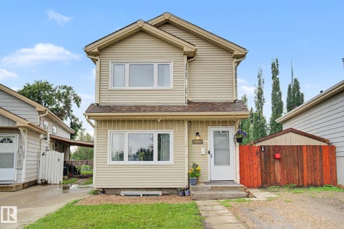 Two-story residence featuring light-colored siding and a brown shingle roof - 18407 95A Avenue Nw, Edmonton, AB - Outdoor