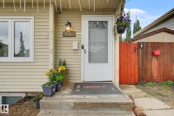 Exterior entry featuring horizontal siding, a white screen door, and a concrete stoop - 