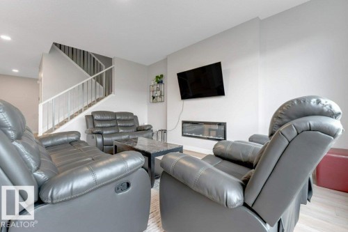 7017 54 Avenue, Beaumont, AB - Indoor Photo Showing Living Room With Fireplace