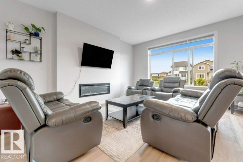 7017 54 Avenue, Beaumont, AB - Indoor Photo Showing Living Room With Fireplace