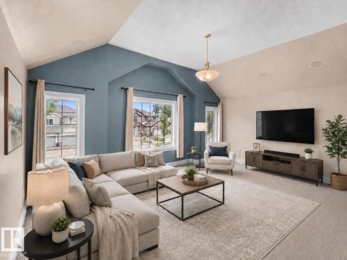 Spacious living area featuring vaulted ceilings, multiple windows, recessed lighting, a modern light fixture, and a built-in media console - 1338 Rutherford Road Sw, Edmonton, AB - Indoor Photo Showing Living Room