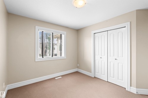 Neutral-toned room featuring a window with blinds, carpeted flooring, and white trim - 1338 Rutherford Road Sw, Edmonton, AB - Indoor Photo Showing Other Room
