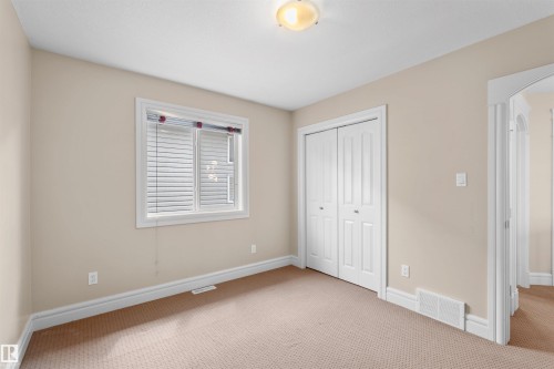 Room featuring neutral wall tones, white trim, and light beige carpeting - 1338 Rutherford Road Sw, Edmonton, AB - Indoor Photo Showing Other Room