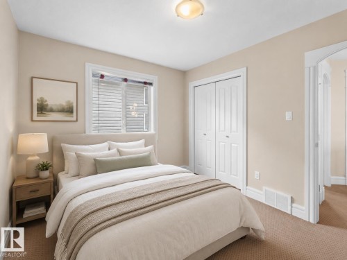 Carpeted bedroom featuring a window with blinds, a ceiling-mounted light fixture, white trim, and a bi-fold closet door - 1338 Rutherford Road Sw, Edmonton, AB - Indoor Photo Showing Bedroom