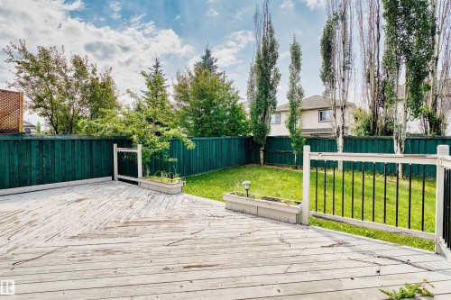 Expansive wood deck with railing and integrated planter boxes - 1338 Rutherford Road Sw, Edmonton, AB - Outdoor With Deck Patio Veranda