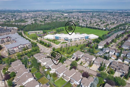 Aerial perspective showcasing a residential neighborhood with detached homes and multi-story apartment buildings - 1338 Rutherford Road Sw, Edmonton, AB - Outdoor With View