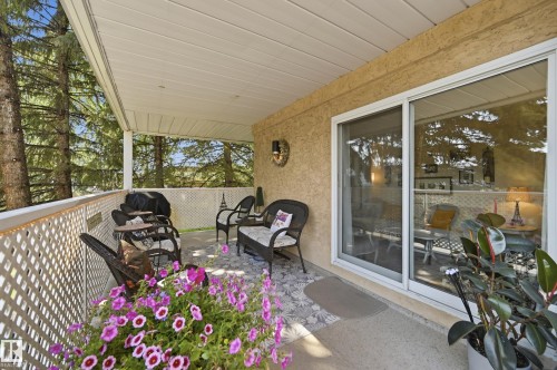 Covered outdoor patio with concrete flooring - #208 9760 176 St Nw, Edmonton, AB - Outdoor With Deck Patio Veranda With Exterior