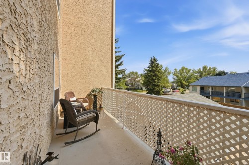 Private balcony featuring a lattice railing and textured exterior wall - #208 9760 176 St Nw, Edmonton, AB - Outdoor