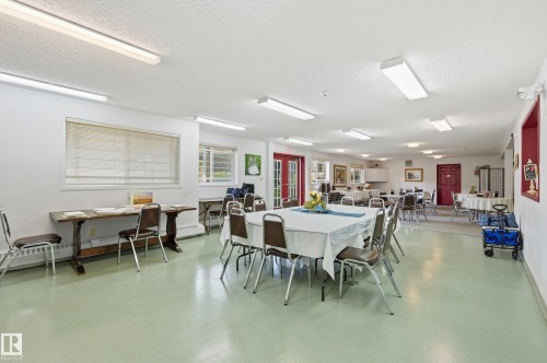 Spacious common area featuring light green flooring, multiple windows with blinds, and white walls - #208 9760 176 St Nw, Edmonton, AB - Indoor Photo Showing Dining Room