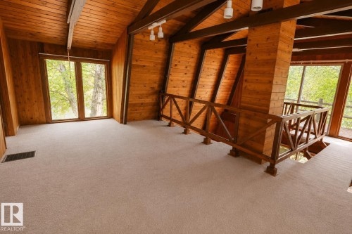 Spacious upper-level room featuring light tan carpeting and expansive windows - 329 60417 Range Road 124, Rural St. Paul County, AB - Indoor Photo Showing Other Room