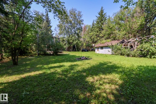 Expansive green space featuring mature trees and a rustic outbuilding - 329 60417 Range Road 124, Rural St. Paul County, AB - Outdoor