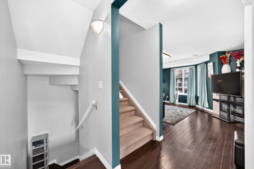 Wood-finish flooring throughout the main level - #72 2505 42 St Nw, Edmonton, AB - Indoor Photo Showing Other Room