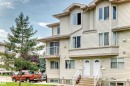 Multi-level exterior featuring light-toned horizontal siding, bay windows, and individual entryways - #72 2505 42 St Nw, Edmonton, AB  - Outdoor 