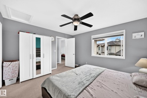 Carpeted room with a ceiling fan, a window, and gray painted walls - #72 2505 42 St Nw, Edmonton, AB - Indoor Photo Showing Bedroom