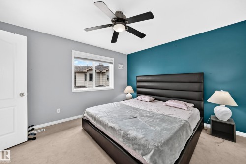 Bedroom featuring a window, carpeted flooring, and a ceiling fan - #72 2505 42 St Nw, Edmonton, AB - Indoor Photo Showing Bedroom