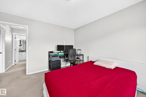 Light gray wall paint, light-colored carpet, and white trim throughout - #72 2505 42 St Nw, Edmonton, AB - Indoor Photo Showing Bedroom