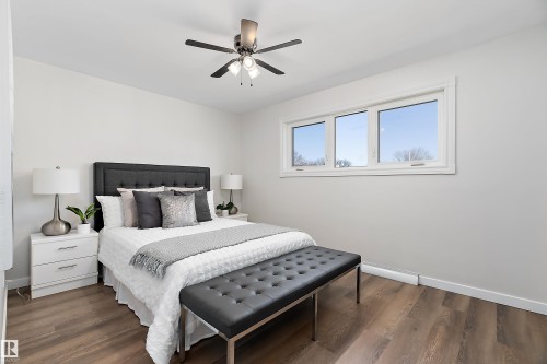 New luxury vinyl plank flooring throughout the main floor. - 9747 66 Avenue Nw, Edmonton, AB - Indoor Photo Showing Bedroom