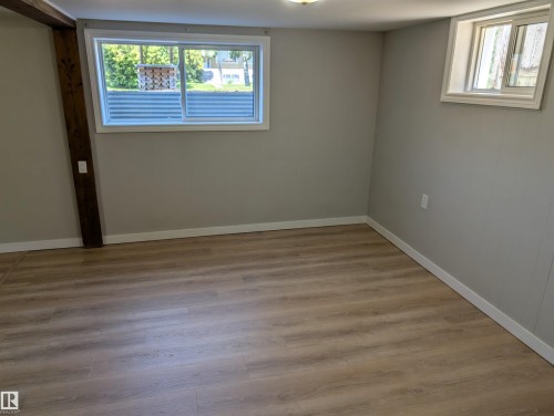 Extra large windows make the basement feel lighter and brighter than basements with smaller windows. - 9747 66 Avenue Nw, Edmonton, AB - Indoor Photo Showing Other Room