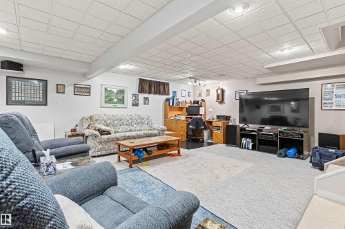 Spacious recreation room featuring recessed lighting and a drop ceiling - #12 64 Blackburn Dr W Sw, Edmonton, AB - Indoor