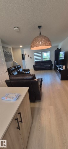 Open-concept living area featuring light wood-finish flooring - 22803 94 Anenue Northwest, Edmonton, AB - Indoor