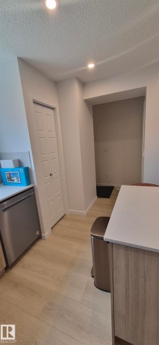 Kitchen space featuring wood-finish flooring, recessed lighting, and a stainless steel dishwasher - 22803 94 Anenue Northwest, Edmonton, AB - Indoor
