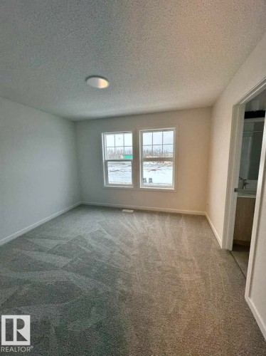 Carpeted room with a textured ceiling and recessed lighting - 22803 94 Anenue Northwest, Edmonton, AB - Indoor Photo Showing Other Room