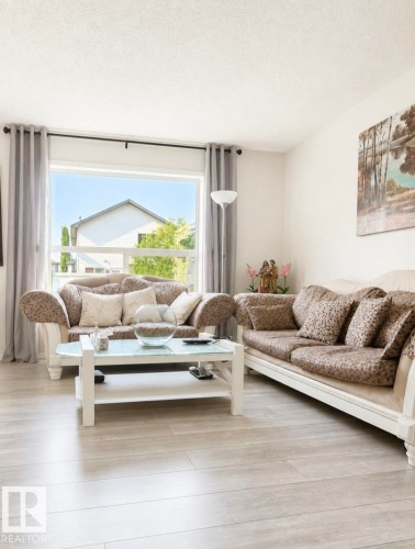 Bright living area featuring light wood-finish flooring - 3236 27 Avenue Nw, Edmonton, AB - Indoor Photo Showing Living Room