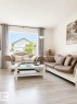 Bright living area featuring light wood-finish flooring - 3236 27 Avenue Nw, Edmonton, AB  - Indoor Photo Showing Living Room 