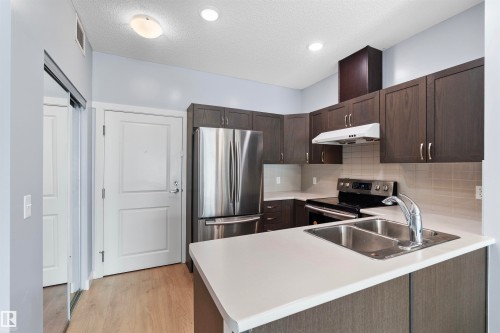 #115 12804 140 Av Nw, Edmonton, AB - Indoor Photo Showing Kitchen With Stainless Steel Kitchen With Double Sink