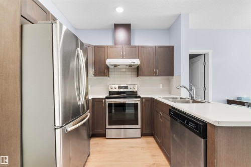 #115 12804 140 Av Nw, Edmonton, AB - Indoor Photo Showing Kitchen With Stainless Steel Kitchen With Double Sink