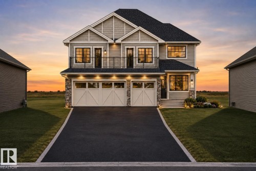 Two-story residence featuring light gray siding with shingle accents, a dark shingled roof, and a two-car garage with white carriage-style doors - 2004 14 Avenue Nw, Edmonton, AB - Outdoor