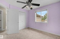 Carpeted interior space featuring a window with blinds, a ceiling fan with integrated lighting, and a bi-fold closet door - 