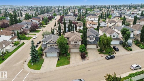 Suburban neighborhood featuring residential properties with mature landscaping and paved streets - 1047 Leger Boulevard Nw, Edmonton, AB - Outdoor With View
