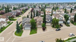 Suburban neighborhood featuring residential properties with mature landscaping and paved streets - 