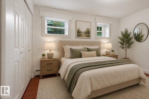 Bright room featuring two windows with white trim, hard surface flooring, and a multi-panel closet with white bi-fold doors - #3 9955 114 St Nw, Edmonton, AB - Indoor Photo Showing Bedroom