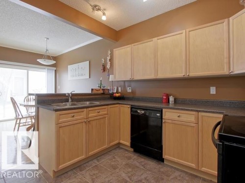 #107 3040 Spence Wd Sw, Edmonton, AB - Indoor Photo Showing Kitchen With Double Sink