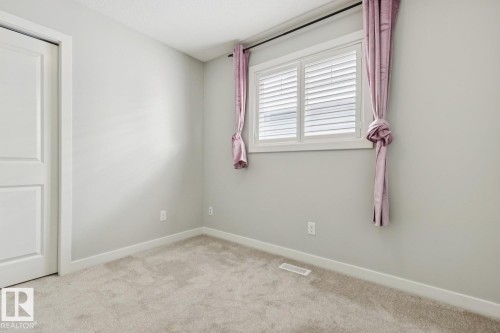 Neutral wall paint, white trim, and light carpet flooring - 4058 Morrison Way Nw, Edmonton, AB - Indoor Photo Showing Other Room