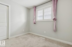 Neutral wall paint, white trim, and light carpet flooring - 