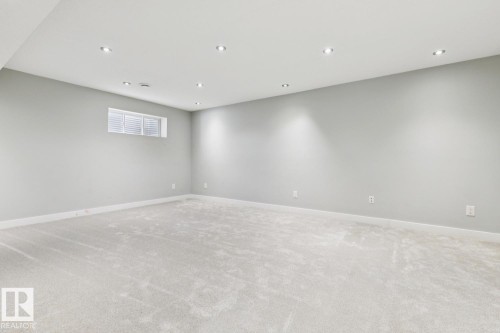 Expansive room featuring light gray carpeting and recessed lighting - 4058 Morrison Way Nw, Edmonton, AB - Indoor
