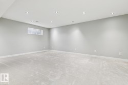 Expansive room featuring light gray carpeting and recessed lighting - 